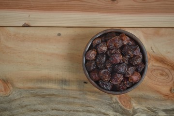 dried dates palm fruit on a old wooden table.
