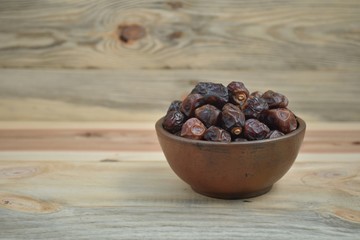 dried dates palm fruit on a old wooden table.