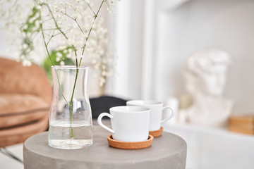 White cups on a concrete table. two cups of hot coffee. Concept of renting an apartment or bed and Breakfast