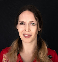 Emotion. Closed woman face with facial expressions over black background