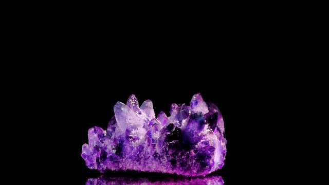 Amazing colorful Quartz Purple crystal cluster isolated on black background, Angel aura mineral. Macro of beautiful raw mineral stone