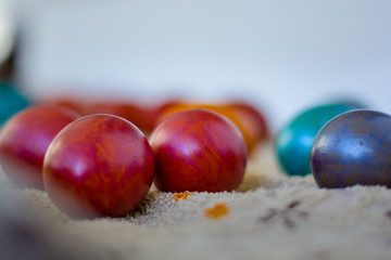 A close image of many colorful Еaster eggs waiting for their paint to dry.