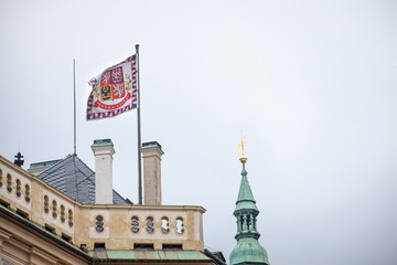 Official flag standard of the president of Czech Republic floating above Prague Castle (Prazsky Hrad) with its slogan in Czech, Pravda Vitezi, meaning justice prevails