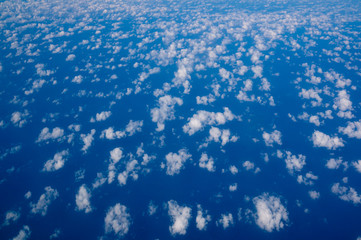 small cirrus clouds high in the blue sky