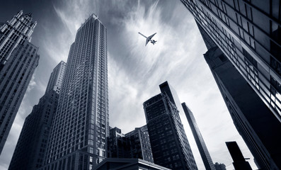 Fototapeta na wymiar skyscrapers and airplane in sky in new york