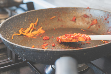 pasta and tomato sauce leftovers on a dirty pot 