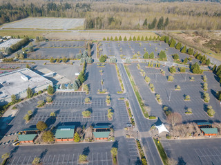 Aerial image of the abandoned parking lot at an outlet mall due to the coronavirus stay home order © rwydro