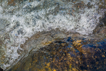 a combination of bubbling water and a wave of smooth surface