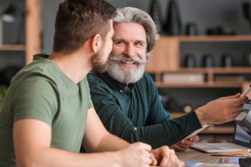 Mentor teaching young photographer in studio