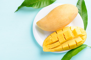 Ripe mango fruit sliced to cubes on white plate ready to eating, tropical fruit, Thai mango (Nam...