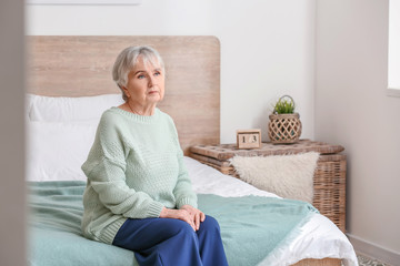Elderly woman suffering from mental disability at home