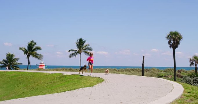 Girl walking two adopted dogs in park