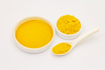 Dry turmeric powder and honey isolated on white background