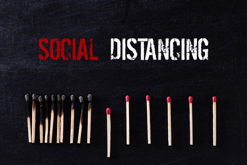 Social Distancing concept. Matchsticks burn, one piece prevents the fire from spreading by far from...