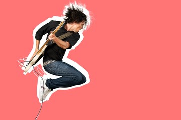Male guitarist playing music on guitar and jump - obrazy, fototapety, plakaty