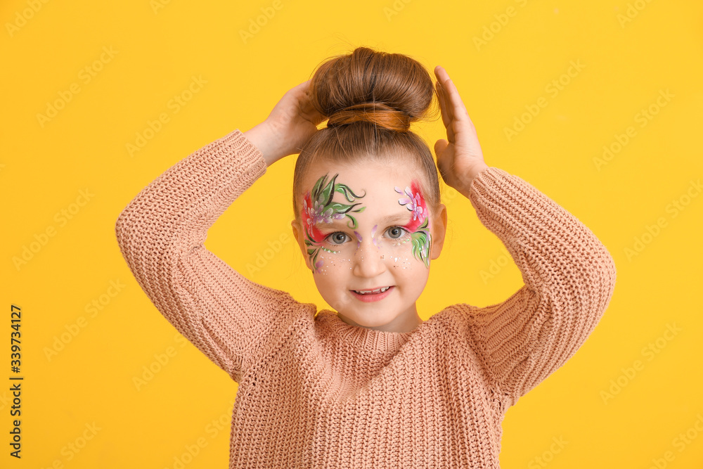 Poster funny little girl with face painting on color background