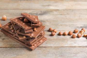 Sweet chocolate with nuts on wooden table