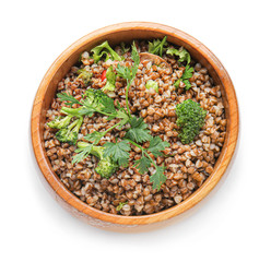 Bowl of tasty buckwheat porridge on white background