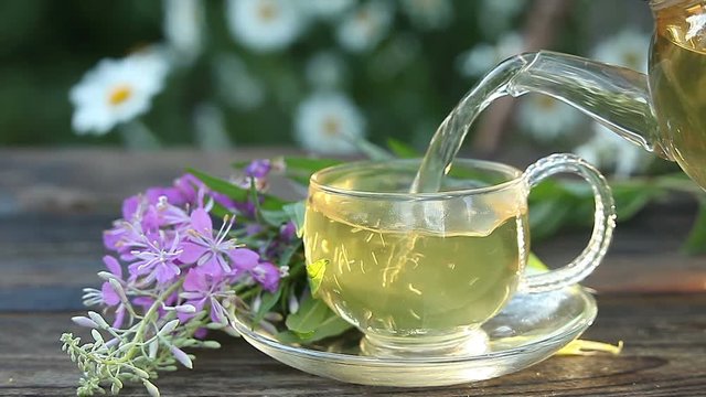 delicious  fireweed tea in a beautiful glass bowl on table