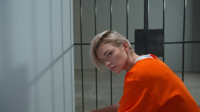 Prison for women. The criminal is sitting in his cell
