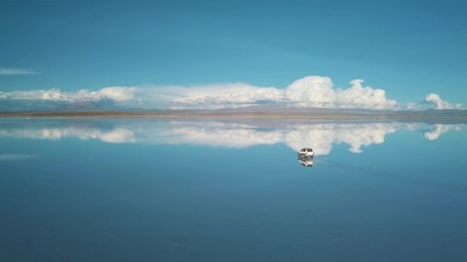 Drone Footage of a car driving at Salar De Uyuni salt flat just before sunset, Blue Hour