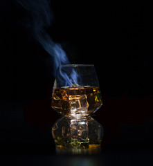 Stylish glass of rum smoking