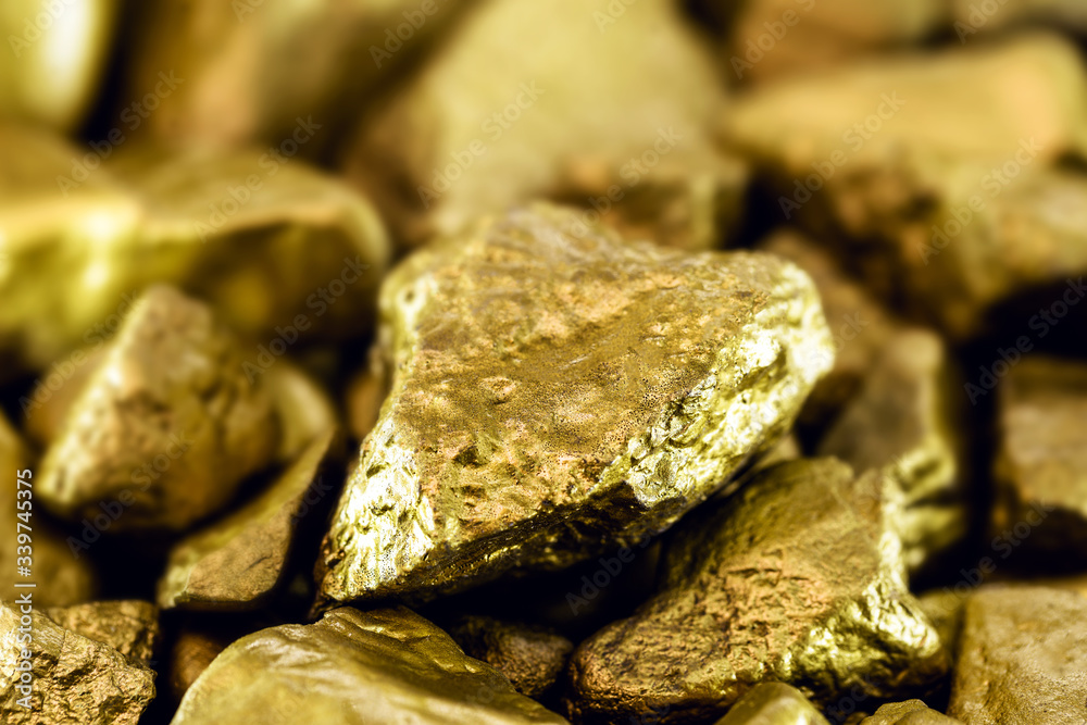 Poster gold stones, rough gold nuggets on black background.