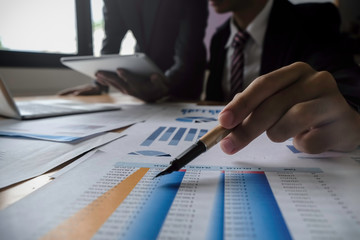 Asian business adviser meeting to analyze and discuss the situation on the financial report in the meeting room.Investment Consultant,Financial Consultant,Financial advisor and accounting concept