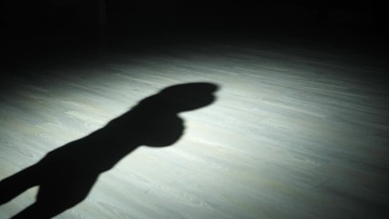 The silhouette of the magician wears the cylinder.