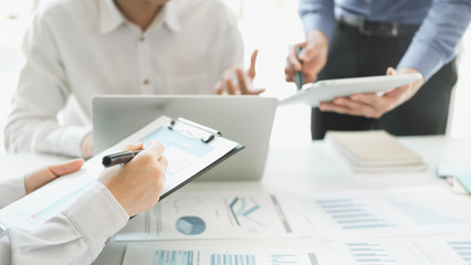 Business man supervising and secretary to execute business plan and consultant analyzing company annual financial report balance sheet statement working with documents graphs. Audit and consultant