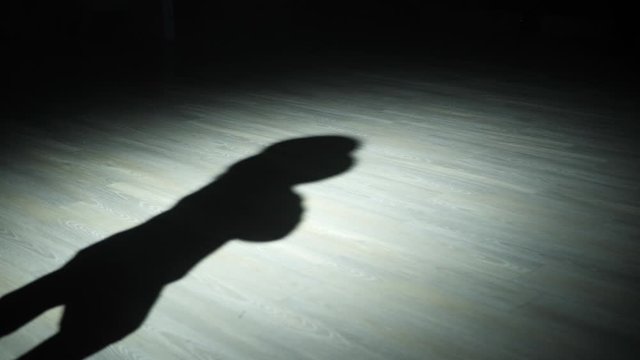 The silhouette of the magician wears the cylinder.