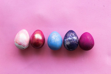 Multi-colored Easter eggs on an isolated white background, top view