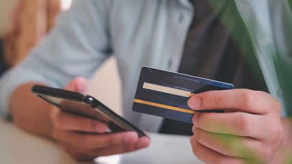 asian young business hands holding credit card and using laptop smart phone Online shopping Website,Article, Blog.Easy Ecommerce Website Shop Online by Smartphone.Online shopping concept