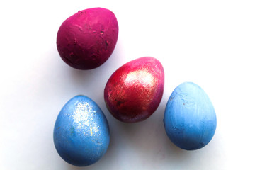 Four multi-colored easter eggs isolated on white background, top view