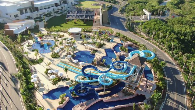 Aerial view of tropical resort with adventure waterpark, aquapark, water slides and swimming pool area, family fun in vacation, Punta Cana in Dominican Republic, all inclusive travel and leisure
