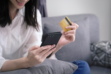 asian young business hands holding credit card and using laptop smart phone Online shopping Website,Article, Blog.Easy Ecommerce Website Shop Online by Smartphone.Online shopping concept