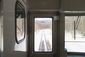 The train tracks in Hokkaido are covered by snow along the route.