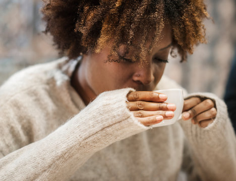 Woman sipping on a hot coffee