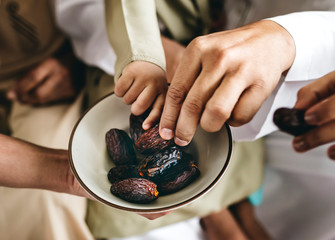 Muslim family eating dates