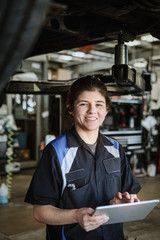 Happy female car mechanic