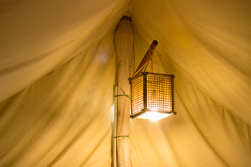 A shot of vintage lamp hanging on bamboo branch