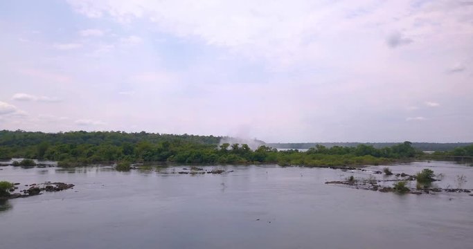 Flying Above Iguazu River With Famous Waterfalls and Water Mist in Background, Brazil Argentina Border, Drone Aerial View