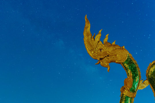 Phayanak Golden King of Naga Heads  Statue   Isolated on milky way background