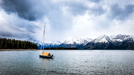 Fototapeta na wymiar storm coming lake mountain boat Grand Teton