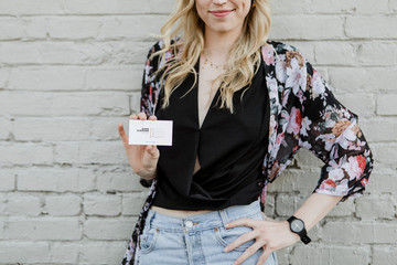 Woman holding business card