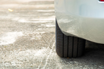 Close up black car tire of a white car parking on the village road for along time, Virus pandemic...