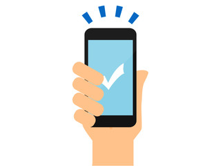 チェックマークとスマートフォンを持つ手