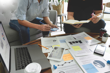 Business people writing on sticky notes for colleagues thinking strategy business plan or over problem in coworking office, Diverse Brainstorm Business Meeting Concept.