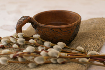 willow twigs next to an earthenware mug