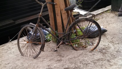 Naklejka na ściany i meble Bicycle On Sand Parked By Wooden Planks